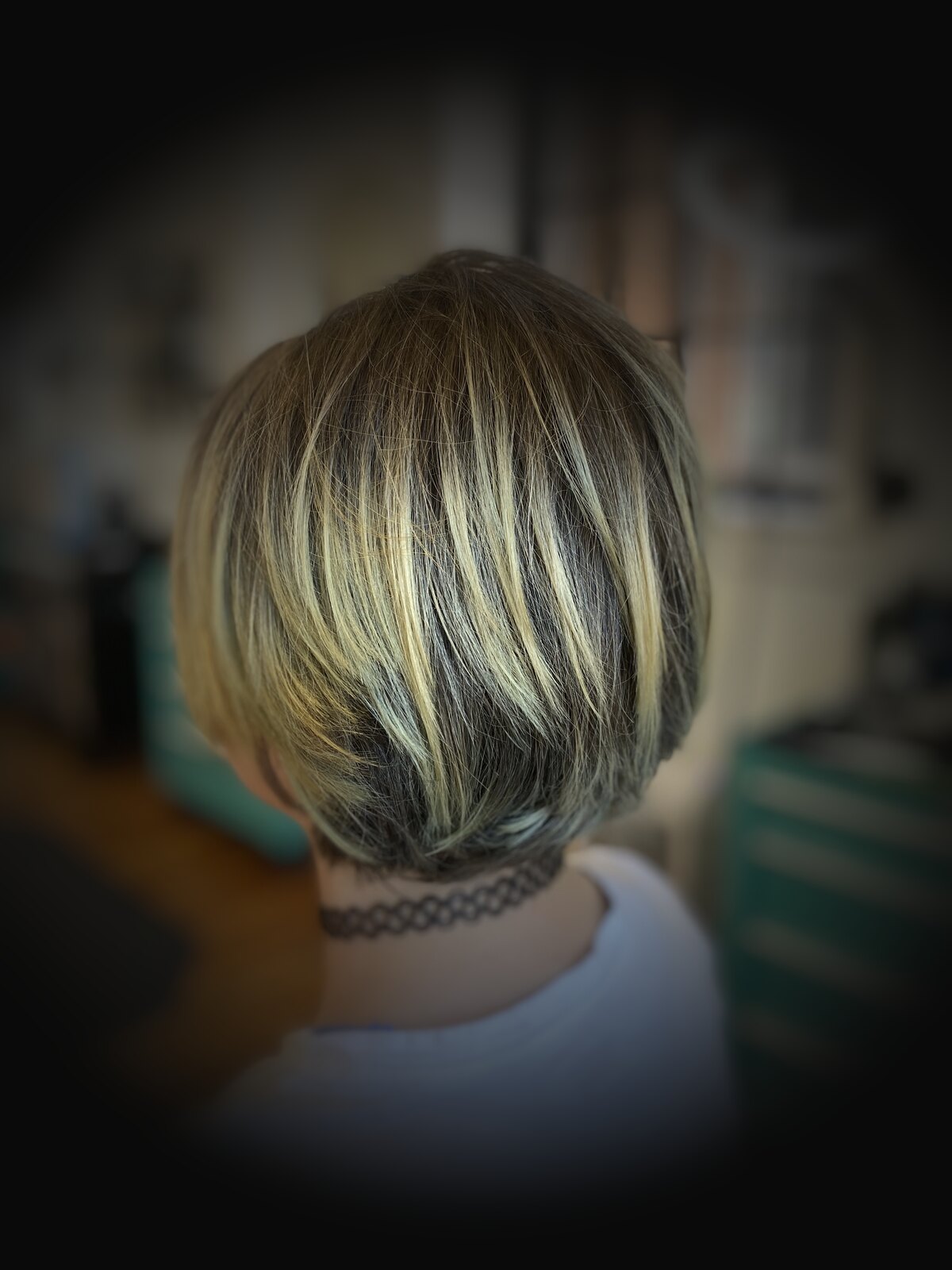 Women's stacked bob with blonde highlights